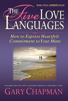 Book cover for the book called The Five Love Languages by Gary Chapman. It has a purple background with an image of a couple walking along a sandy beach together.